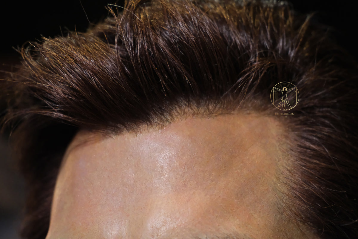 Macro view of manual hair transplantation on the hairline of Salman Khan silicone statue
