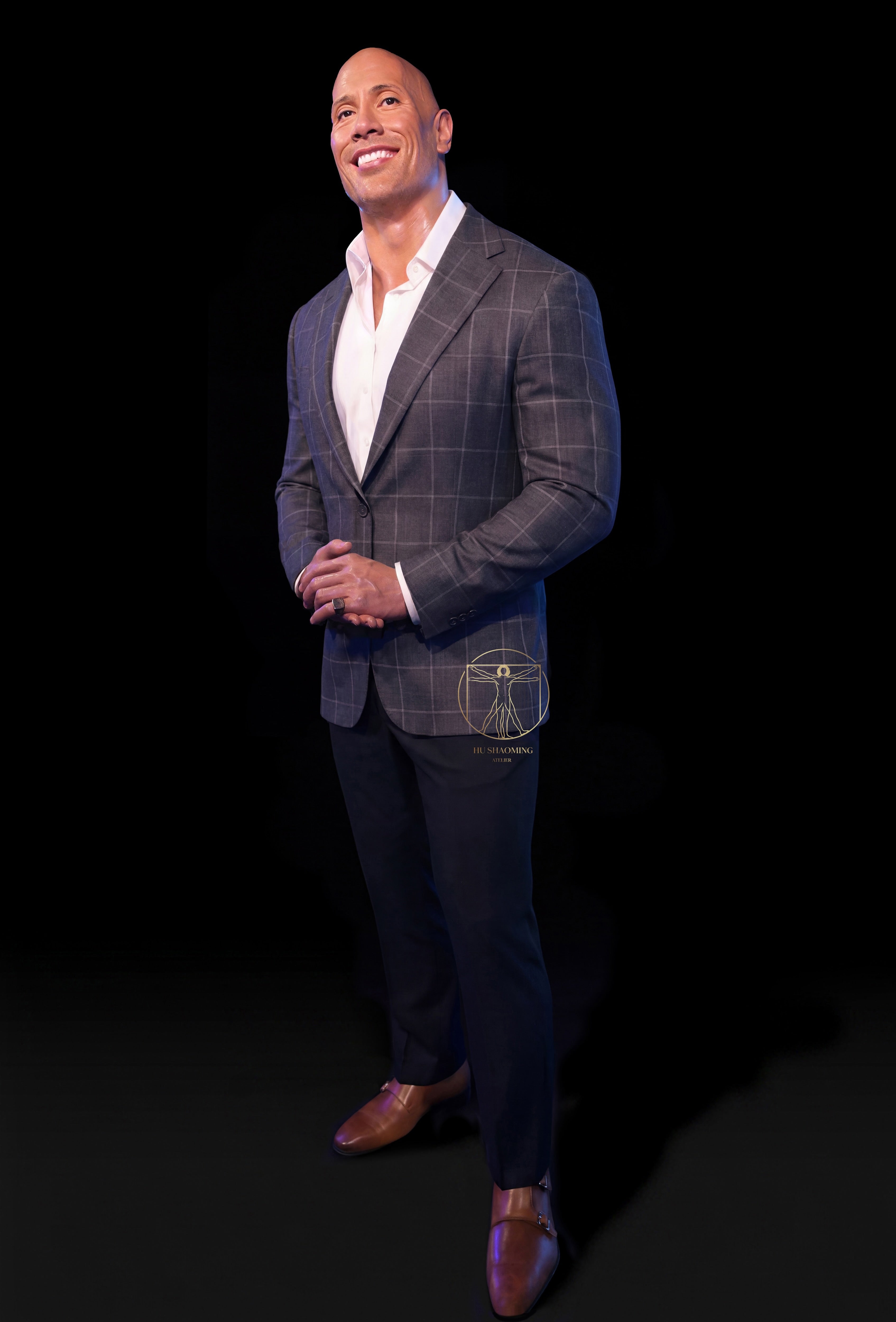 Full body life-size Dwayne Johnson custom wax-style statue in a grey plaid suit