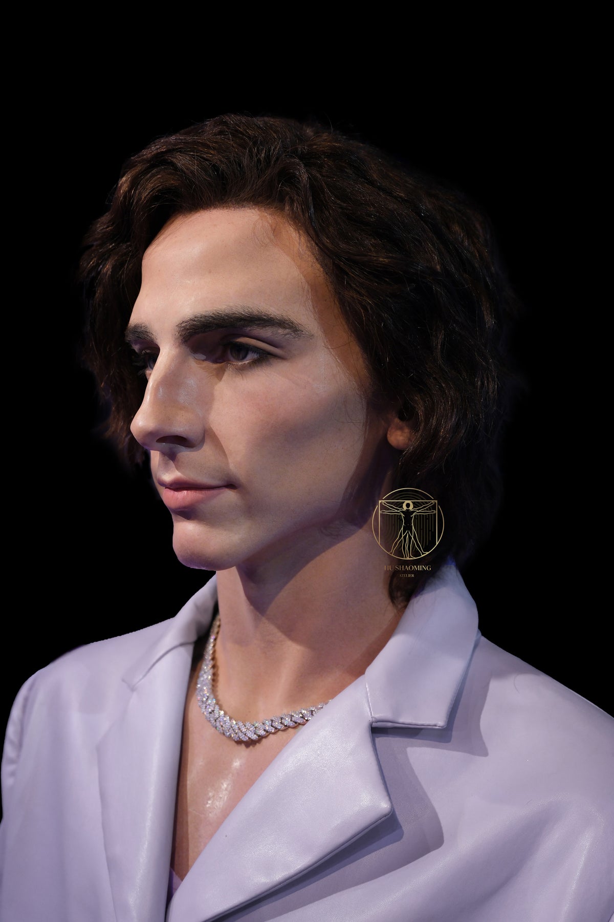 High-detail realistic portrait sculpture of actor Timothée Chalamet in a white collar jacket